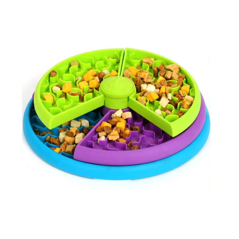 Slow feeder puzzle bowl with green, purple and blue compartments filled with kibble