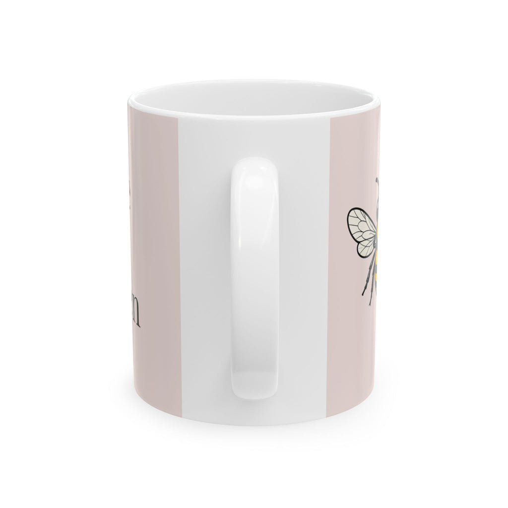 Pink ceramic mug with side bee illustration and white handle