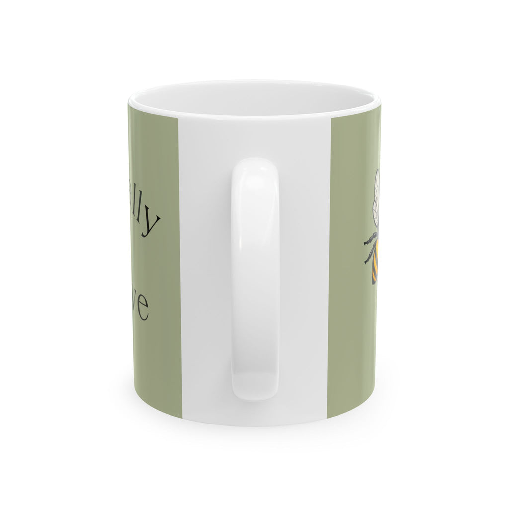 Green ceramic mug with white interior and vertical molded grip panel on side