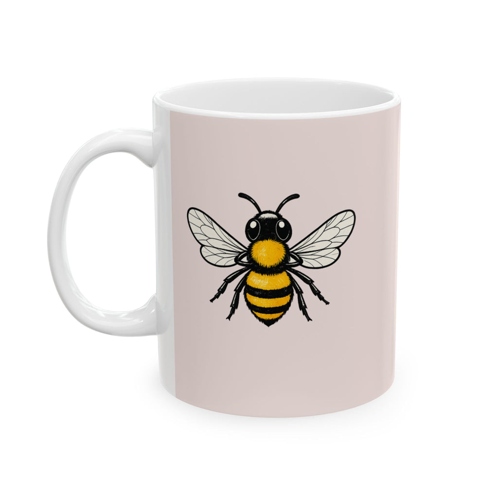 Light pink mug with black-and-yellow bee graphic and white handle