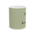 Green bee-themed mug with partial black text and small winged bee icon