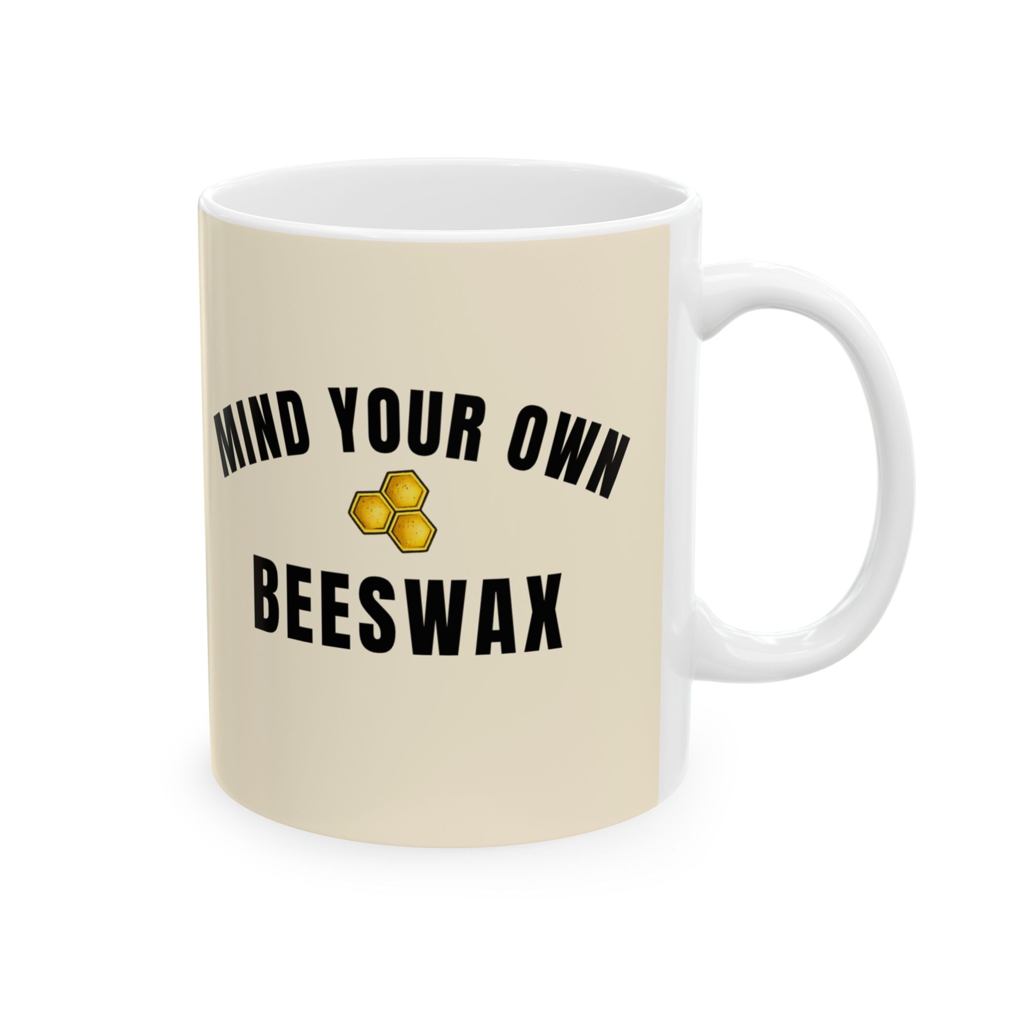 Light cream ceramic mug with “MIND YOUR OWN BEESWAX” text and honeycomb icon
