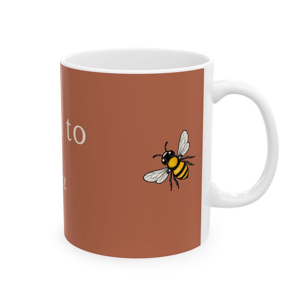 Brown mug with bee graphic and partial “Born” lettering on the side