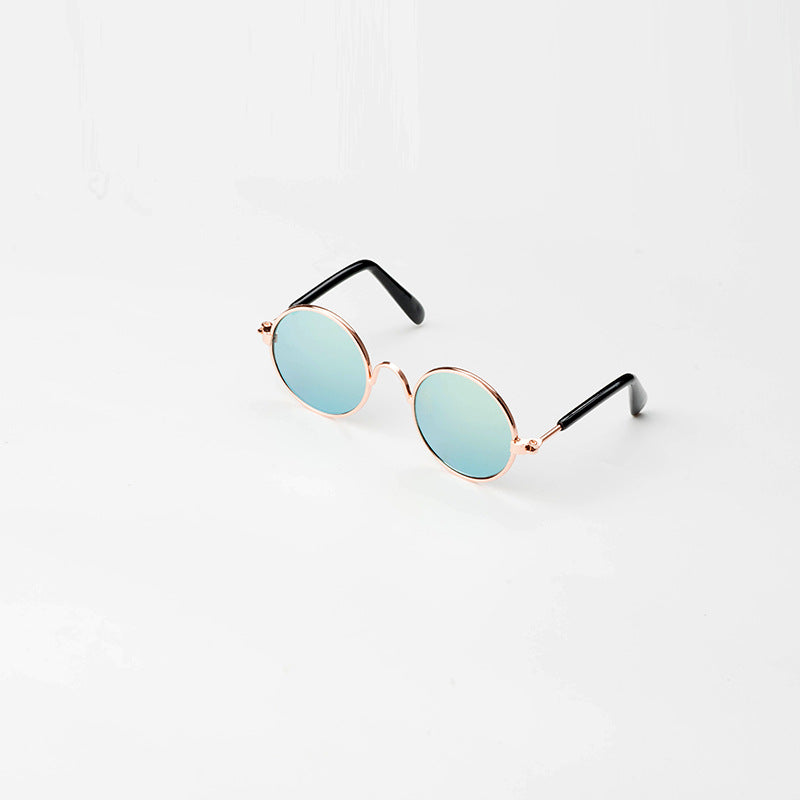 Round pet sunglasses with rose-gold frame, light blue lenses, and black side arms