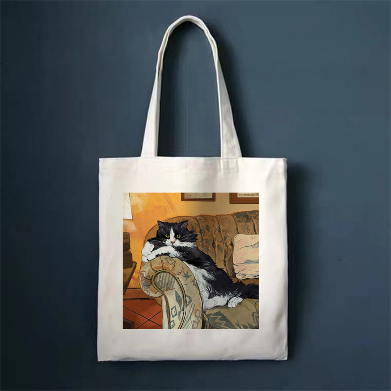 Canvas tote bag, white, with black and white cat on a couch print.