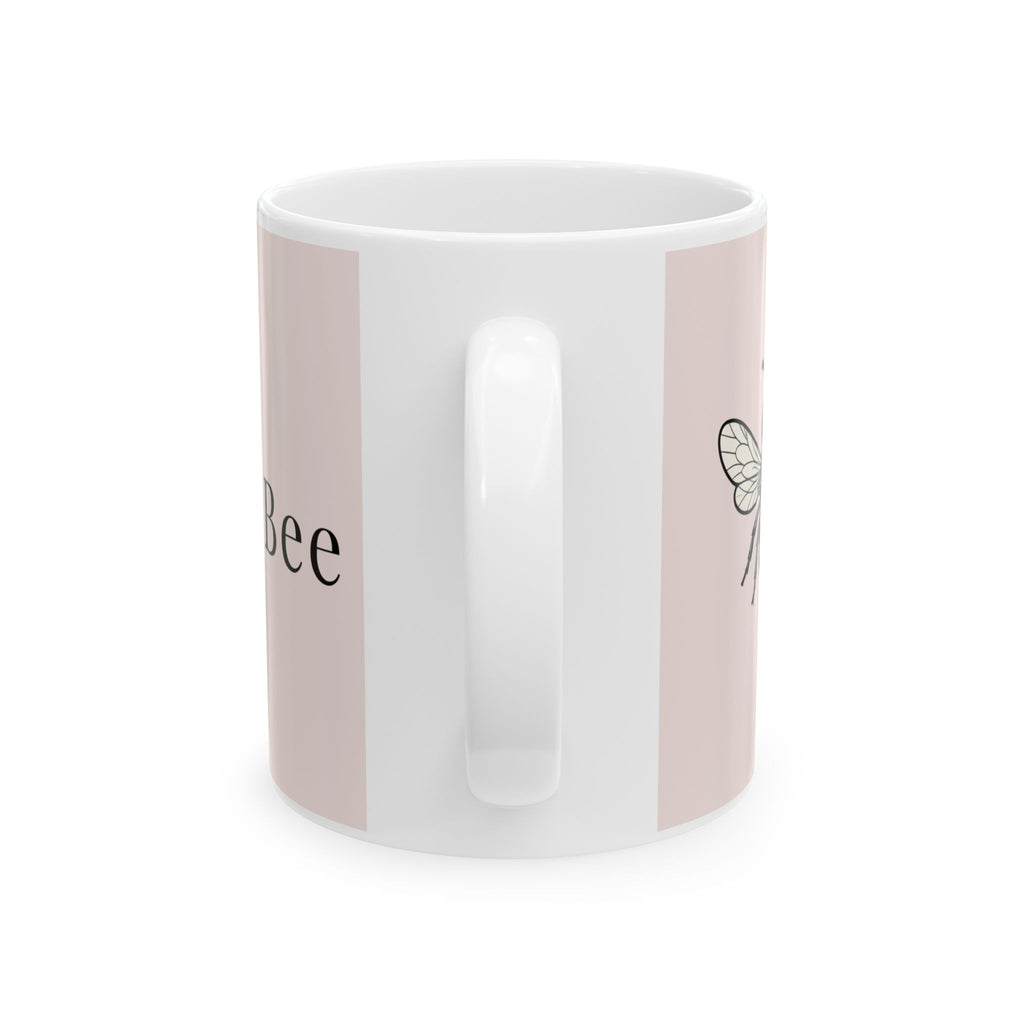 Pink ceramic coffee cup with side bee illustration and white interior