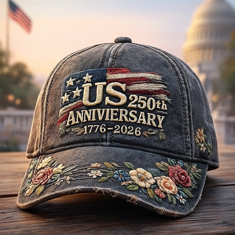 Dark gray baseball cap with “US 250th Anniversary 1776–2026” and embroidered floral brim