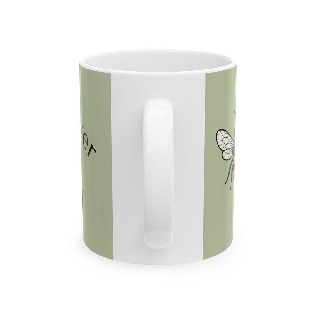Green and white ceramic mug with central grip handle and a small bee line graphic
