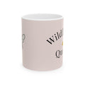 Pink ceramic coffee cup with partial Wildflower Queen text and bee graphic