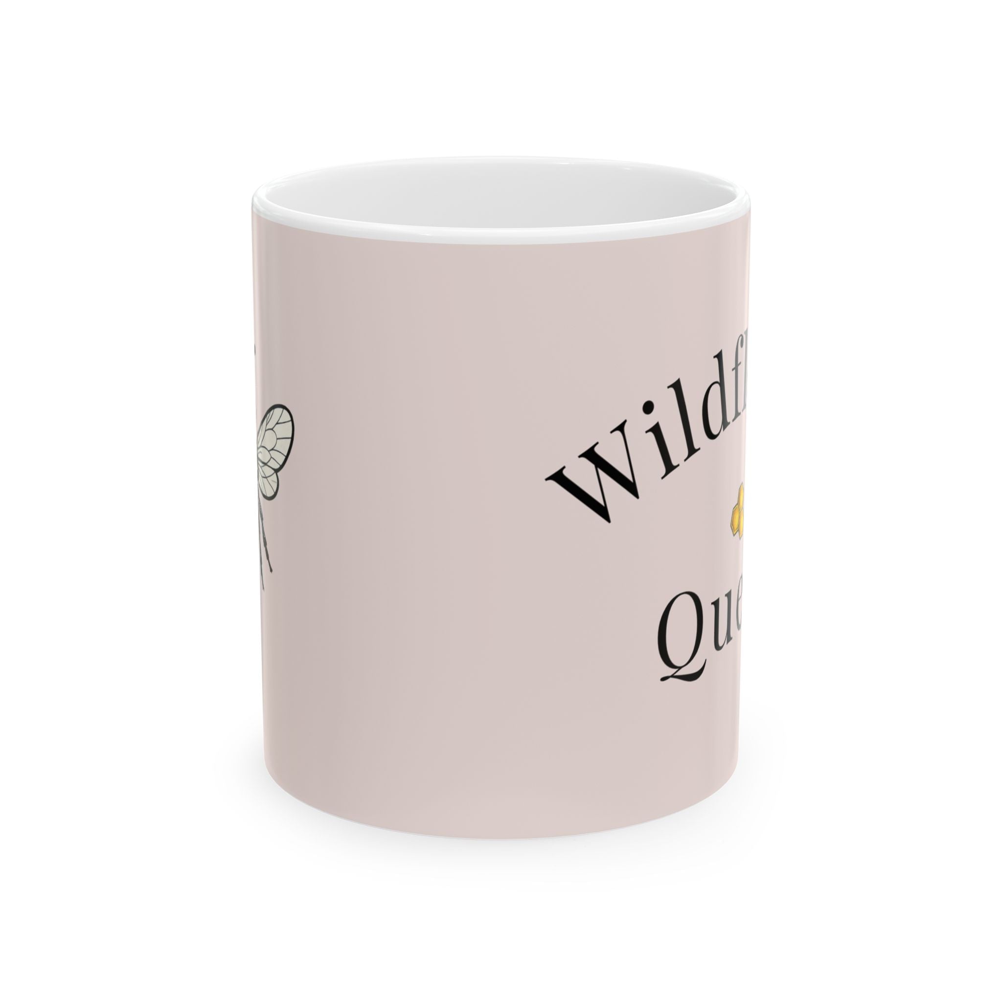 Pink ceramic coffee cup with partial Wildflower Queen text and bee graphic