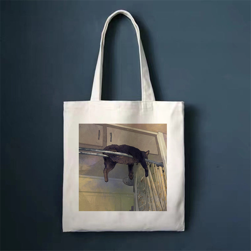 Canvas tote bag with cat photo graphic on front panel and top handles.