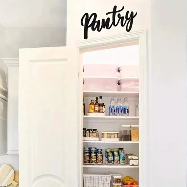 Metal pantry sign with cursive “Pantry” above an open shelf door