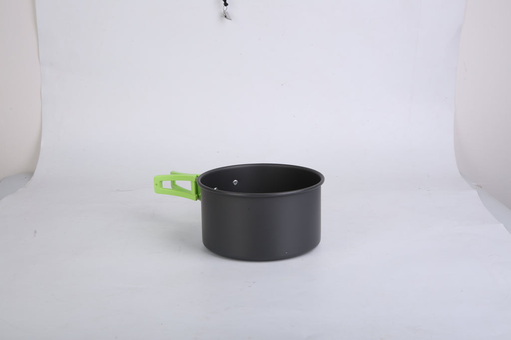 Black cooking pot with green handle and lid loop on white background