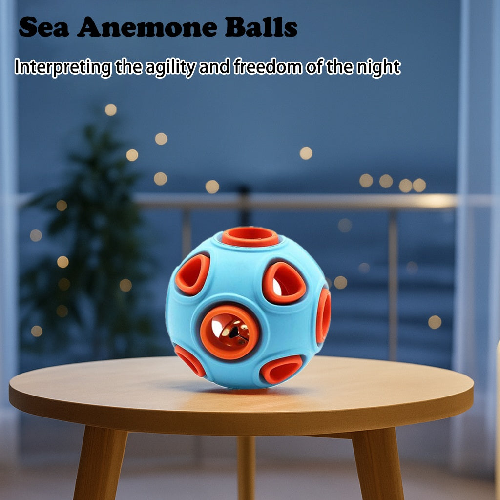 Blue rubber bell toy ball on a round wooden table with orange center
