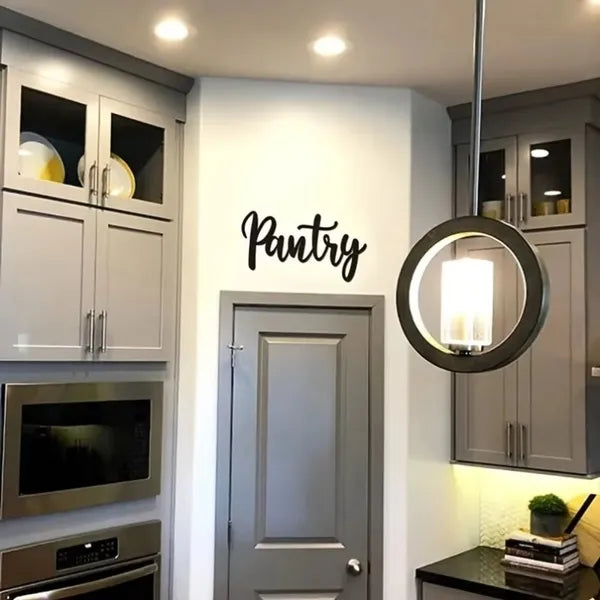 Metal pantry wall sign with cursive “Pantry” on a kitchen wall