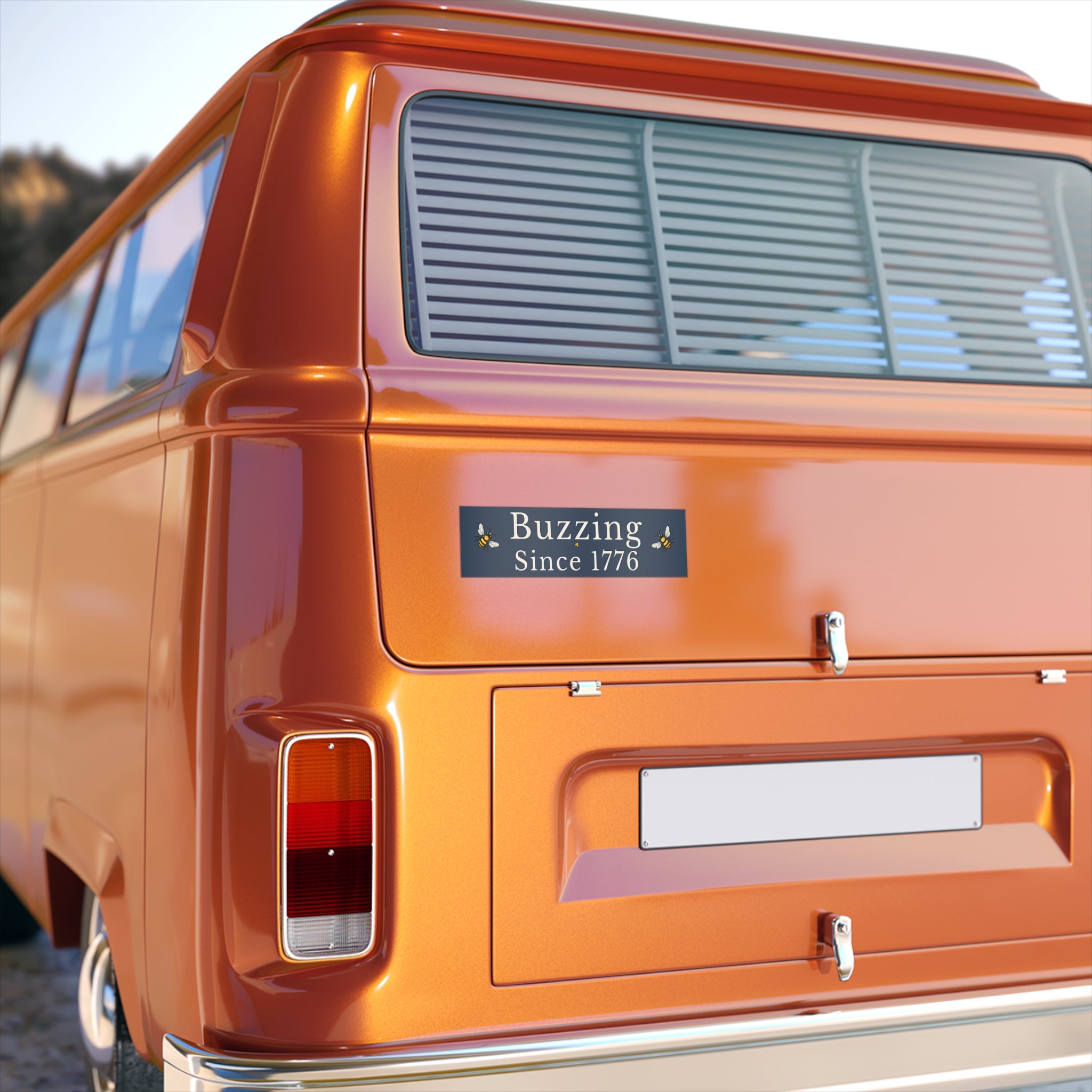 Rectangle bumper sticker on a car rear: 'Buzzing Since 1776' with bee icons