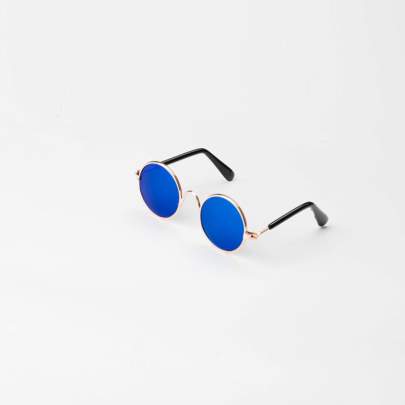 Round pet sunglasses with black side arms, royal blue lenses, and rose-gold frame