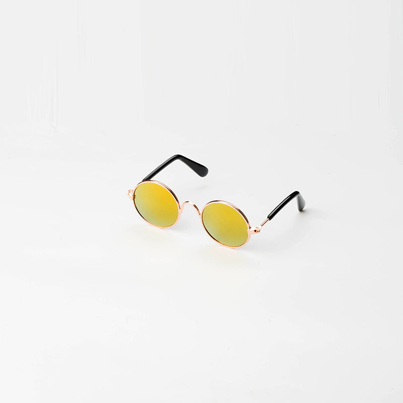 Round pet sunglasses with rose-gold frame, yellow lenses, and black side arms