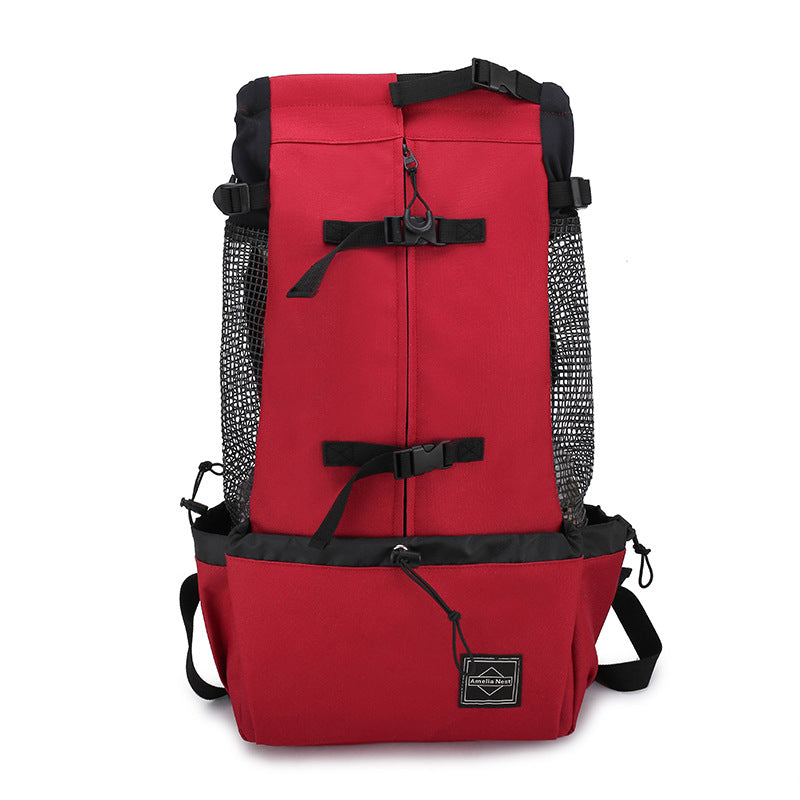 Red pet carrier backpack with black straps, mesh side panels, and front storage pouch