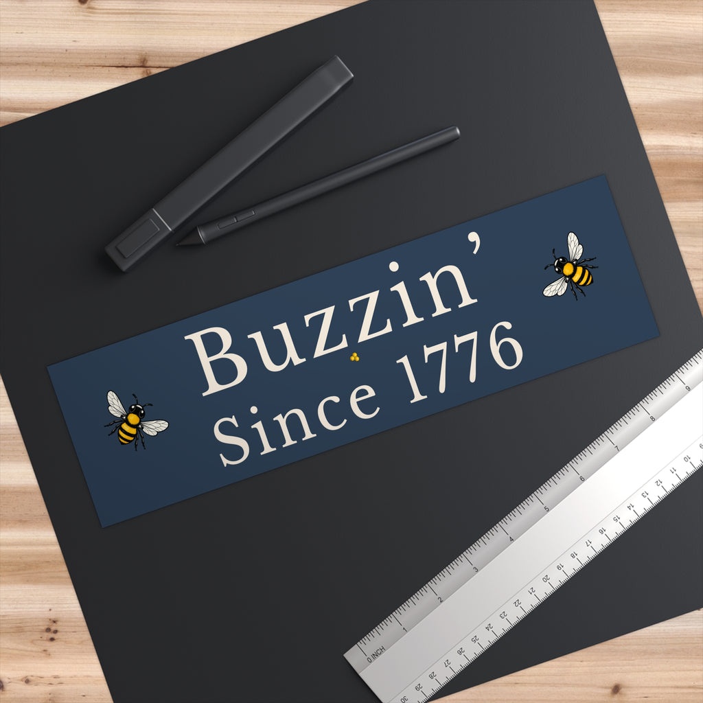 Rectangle bumper sticker, blue with centered white 'Buzzin' Since 1776' and small bees