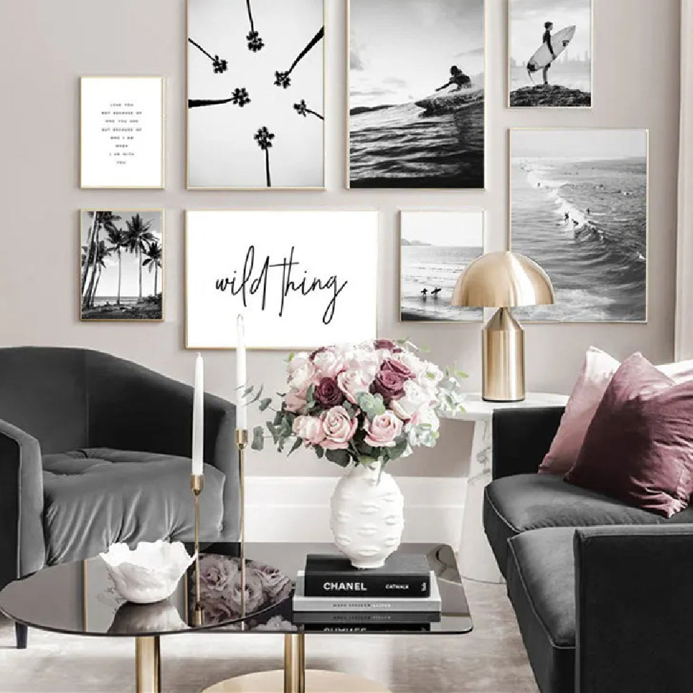 Black-and-white wall poster collage with palm silhouettes and ocean photos