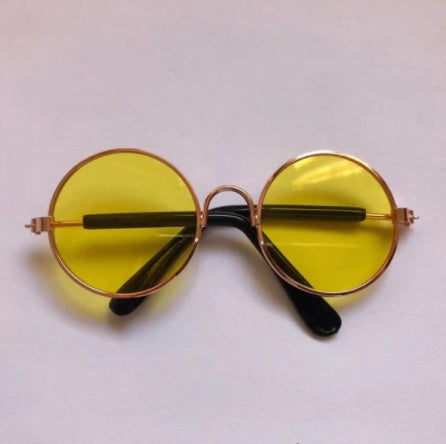 Round sunglasses for pets with yellow lenses and gold-tone frames