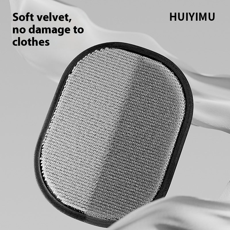 Oval pet hair removal brush pad with light gray soft fabric side and black trim