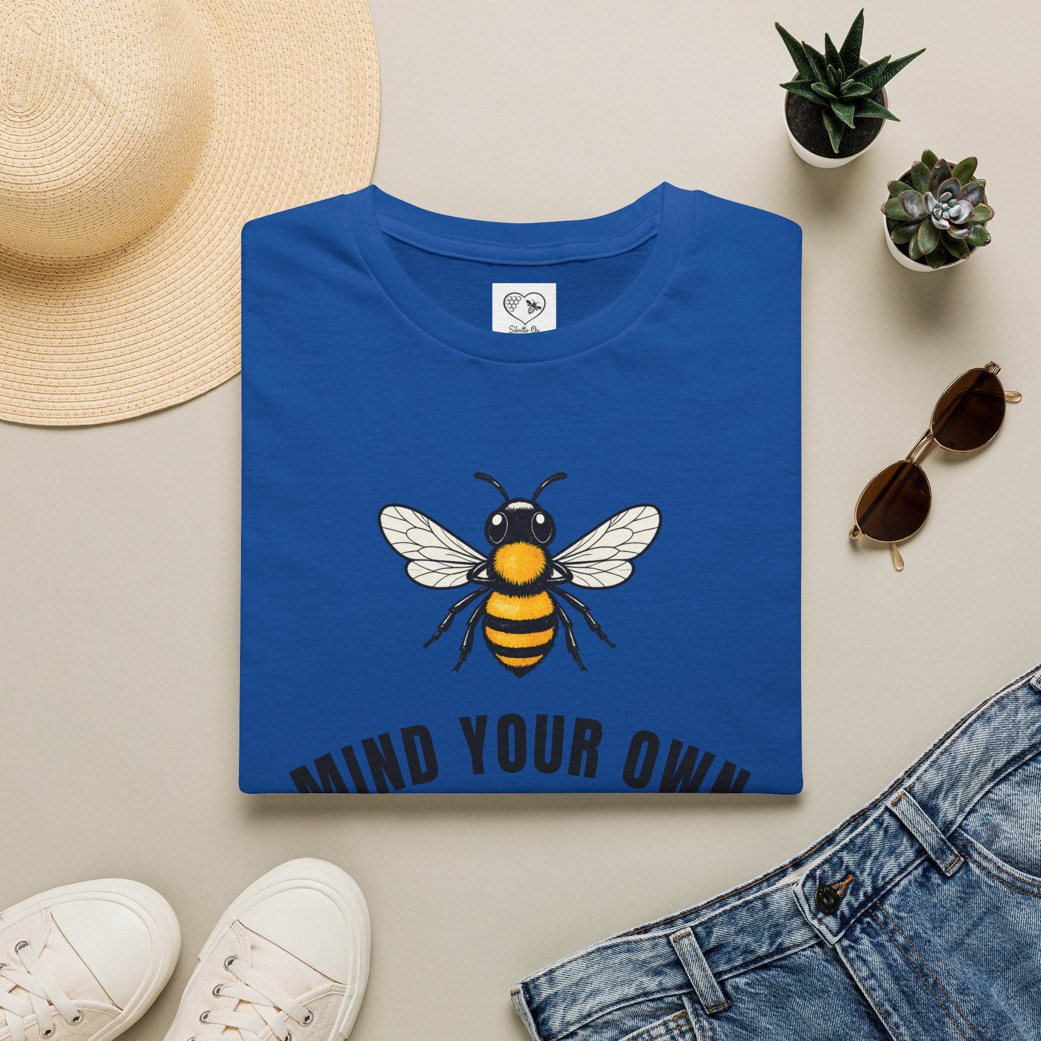 Royal blue t-shirt with bee illustration and bold "MIND YOUR OWN" text on front