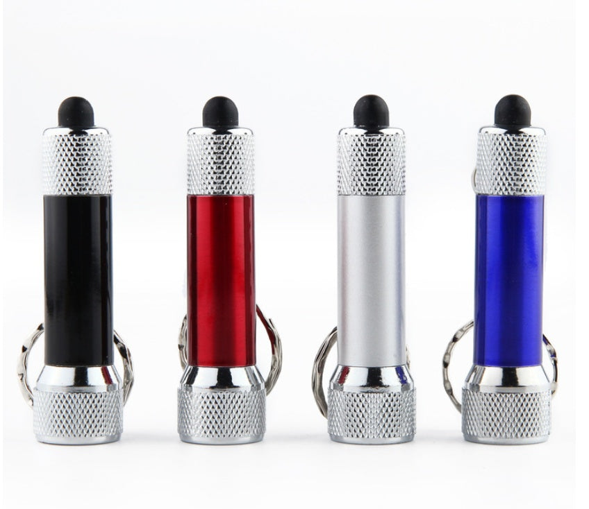 Set of four mini LED keychain flashlights in black, red, white, and blue with keyring