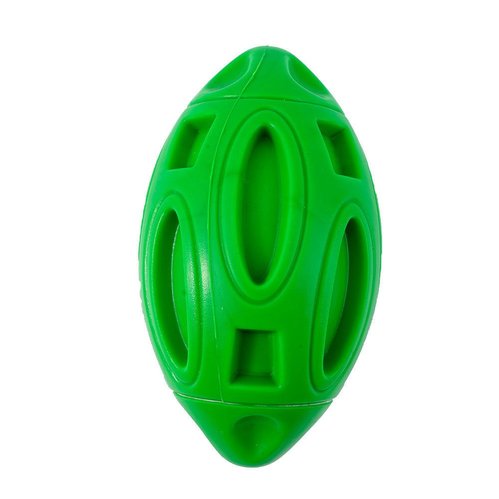 Green squeaky rubber rugby dog toy ball with oval grip openings