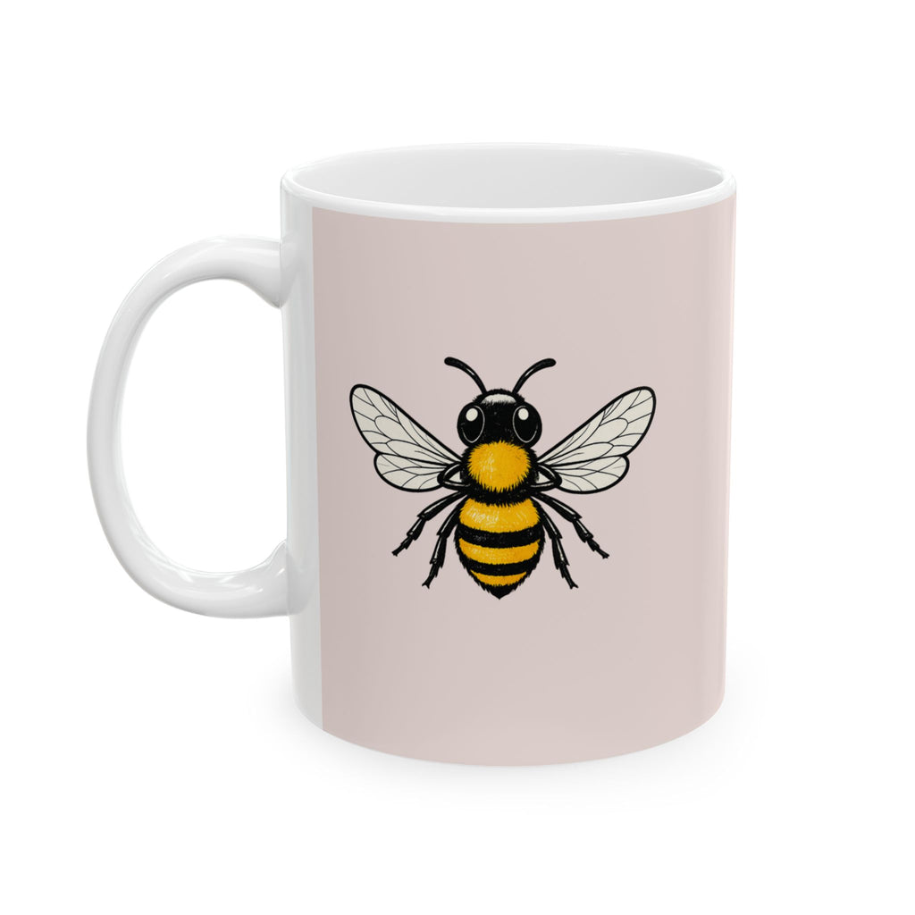 Pink ceramic coffee cup with centered bee graphic and white side handle
