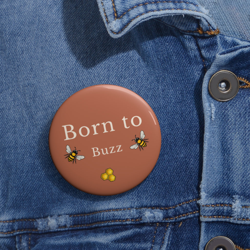 Brown enamel pin button: Born to Buzz text with bee and honeycomb on denim
