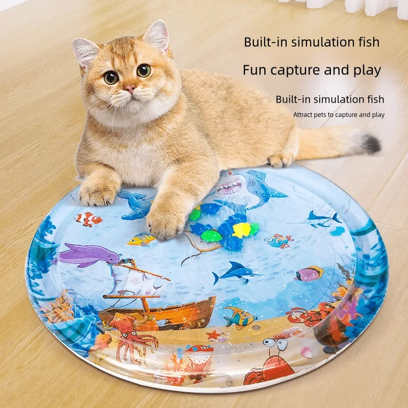 Inflatable pet water cooling bed, round fish-themed ice pad on floor; orange tabby cat on top