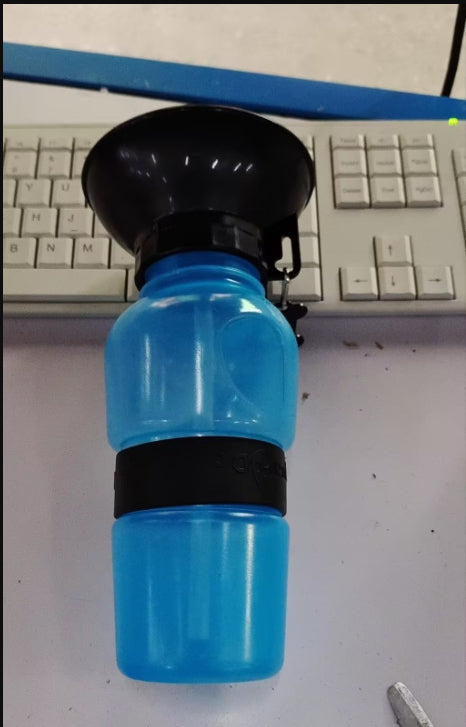 Blue portable pet water bottle with attached drinking bowl and push spout