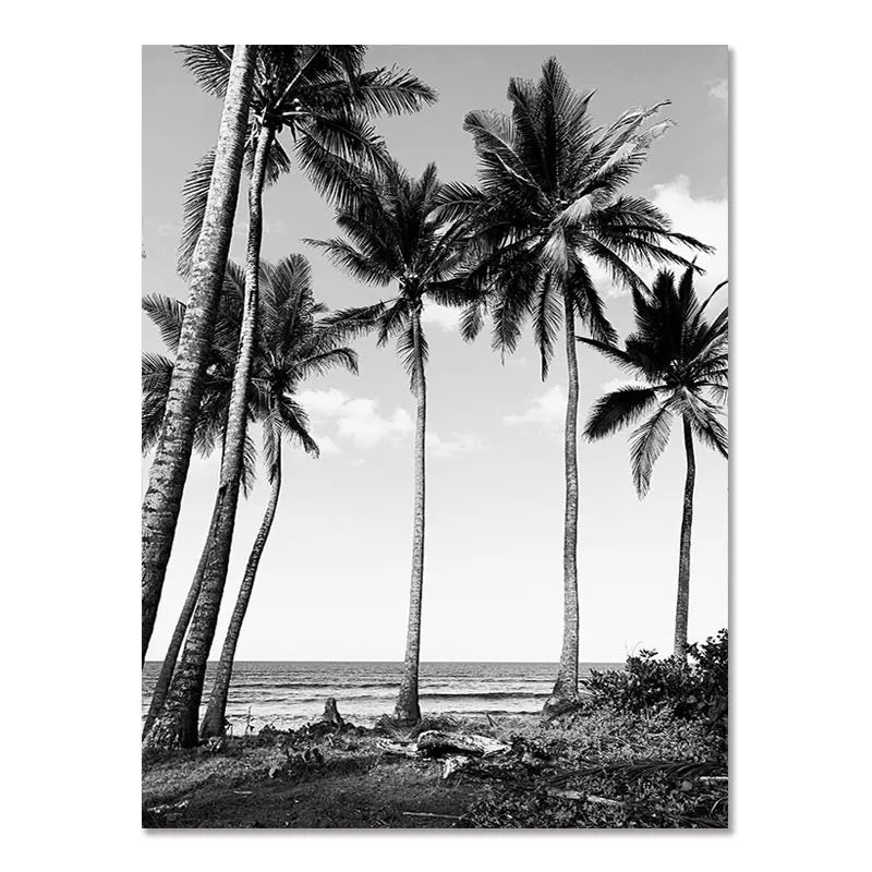 Black-and-white wall poster with tall palm trees by a tropical coastline