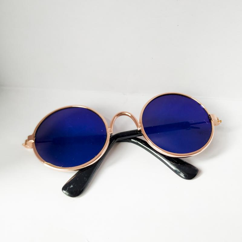 Round pet sunglasses with rose-gold frame, blue lenses, and black side arms