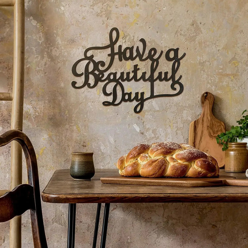 Black iron wall sign reading "Have a Beautiful Day"
