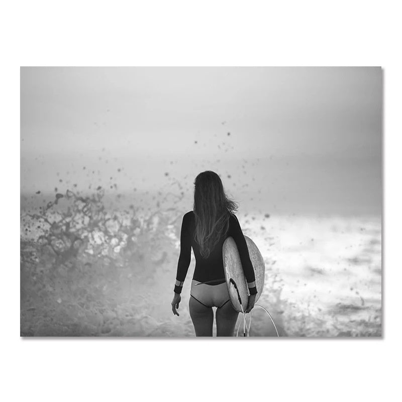Black-and-white wall poster of a person walking on beach toward the ocean
