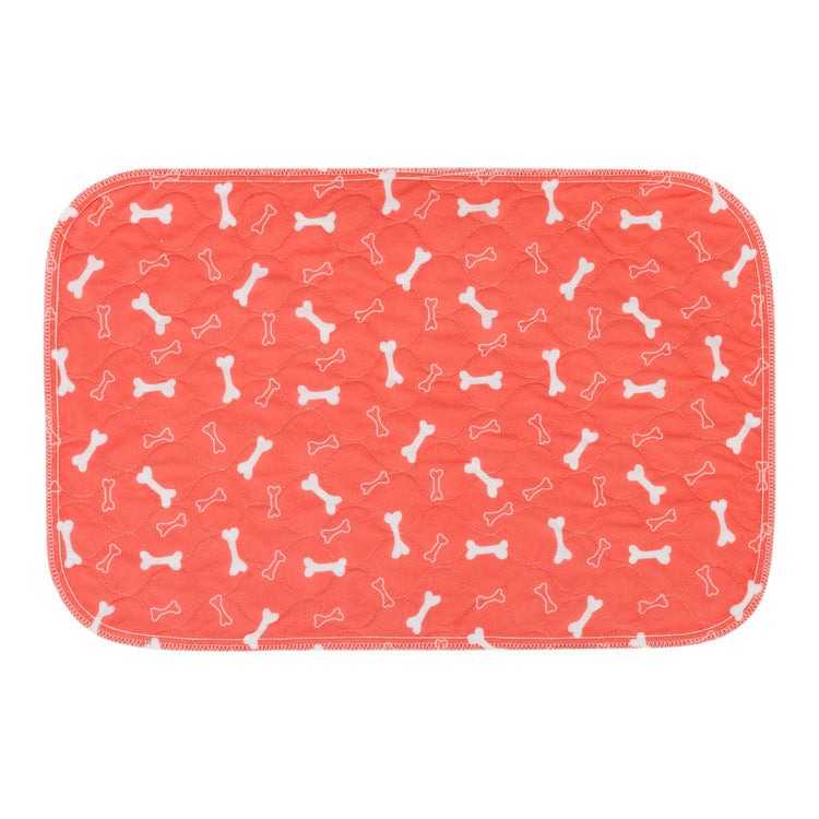 Orange waterproof pet training pad with white bone icon pattern, stitched border