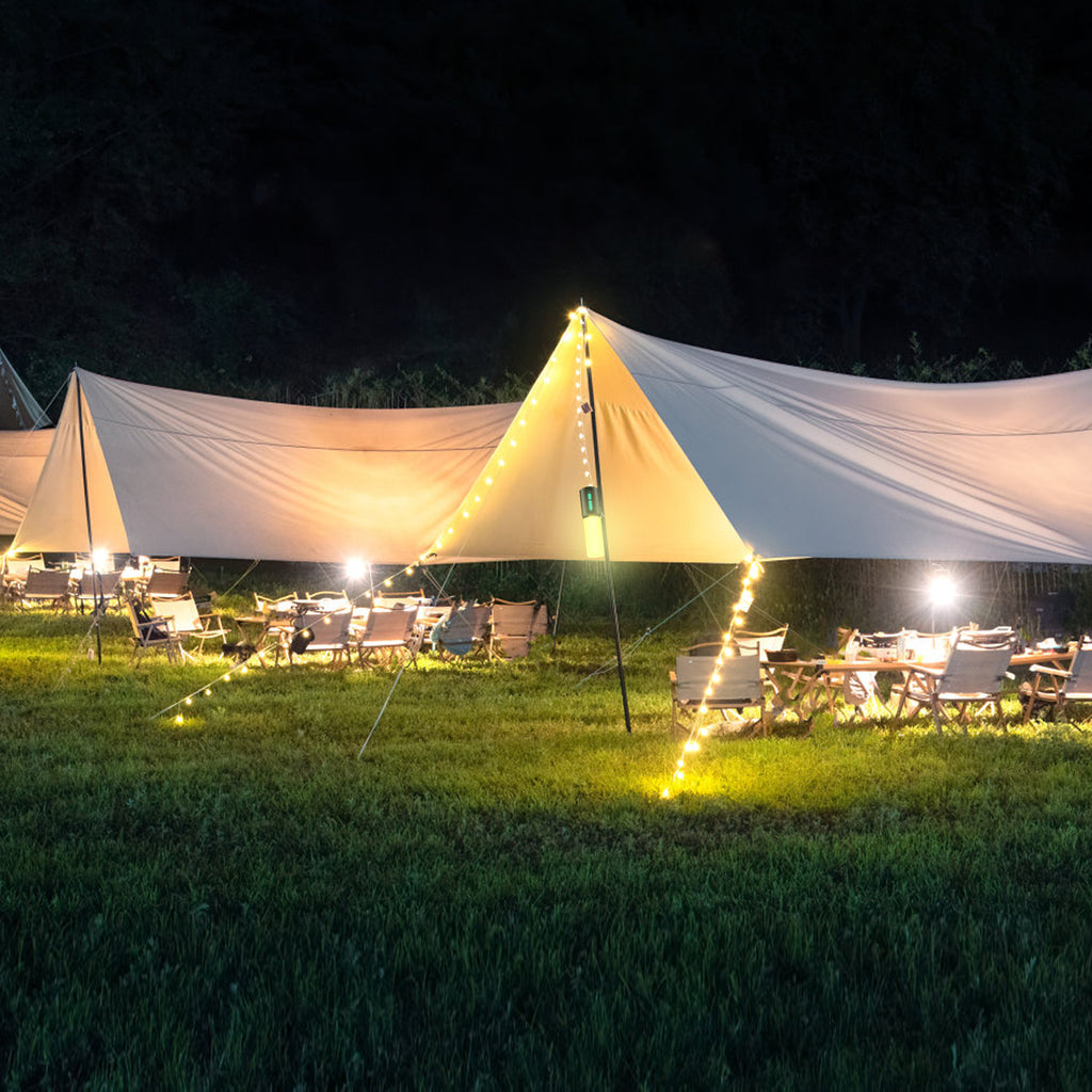 Warm LED string lights draped on a camping tent for outdoor illumination