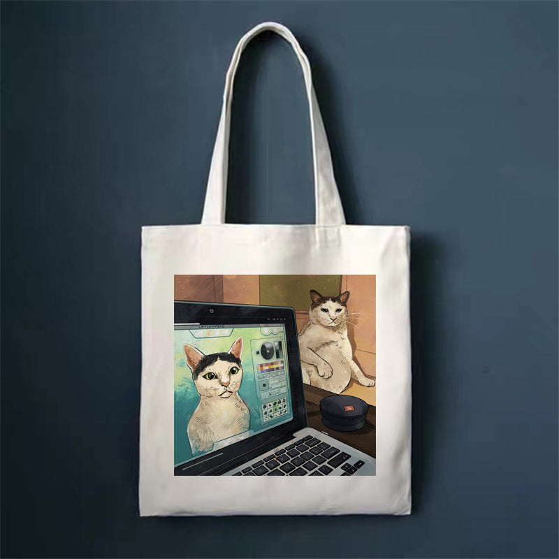 Canvas tote bag, white, with two cats near a laptop print.