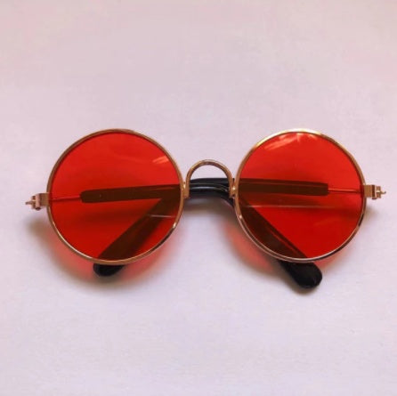 Round sunglasses for pets with red lenses and gold-tone frames