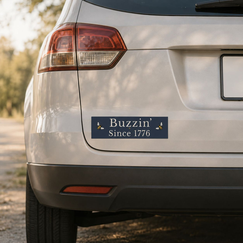 Rectangle bumper sticker on white vehicle, blue with white 'Buzzin' Since 1776' lettering