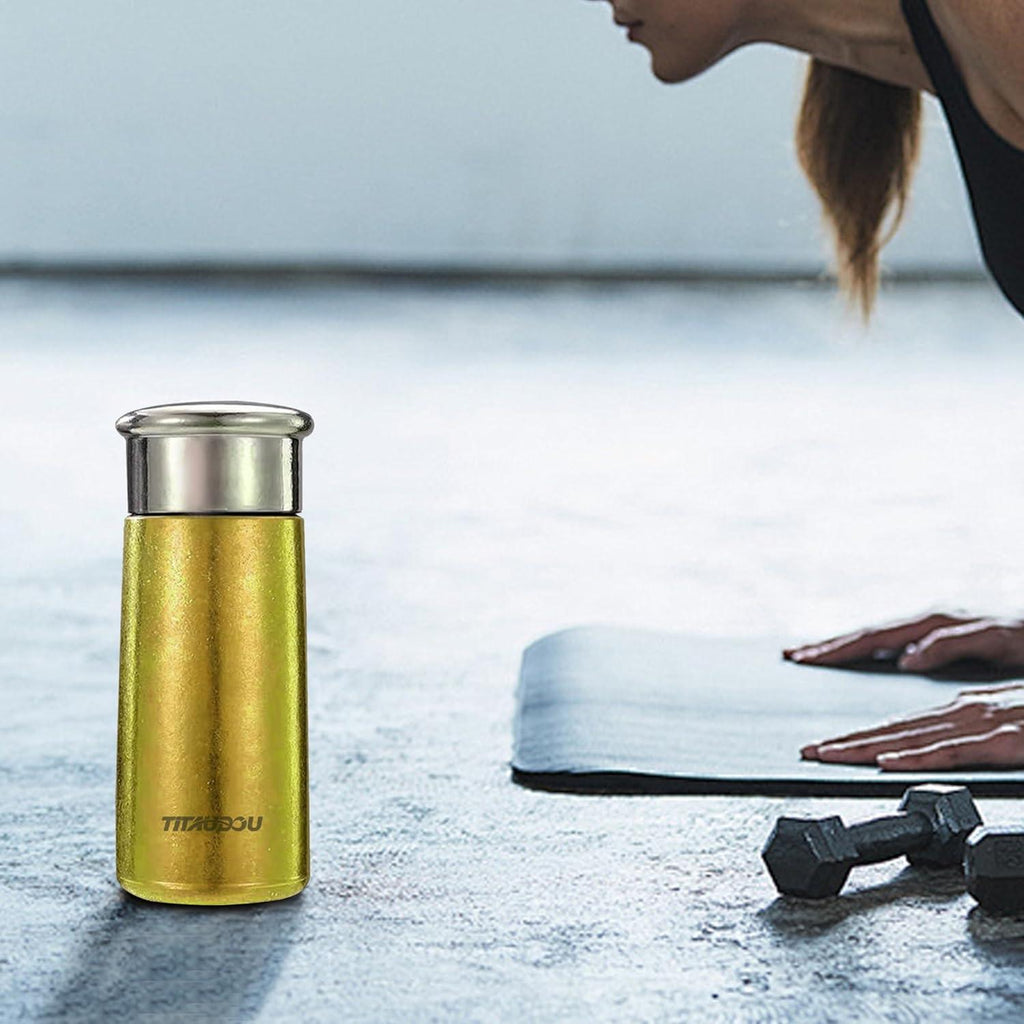 Gold vacuum insulated titanium water cup with stainless steel lid, slim travel bottle