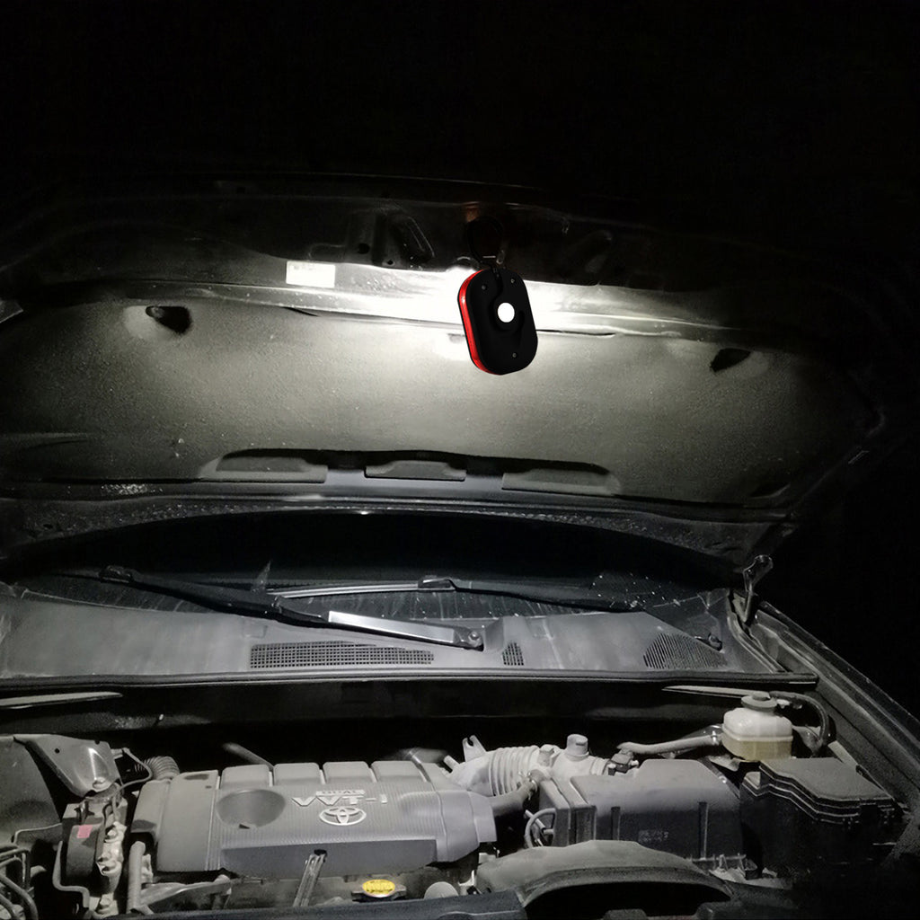 LED work light mounted under a car hood, red and black casing with white LEDs