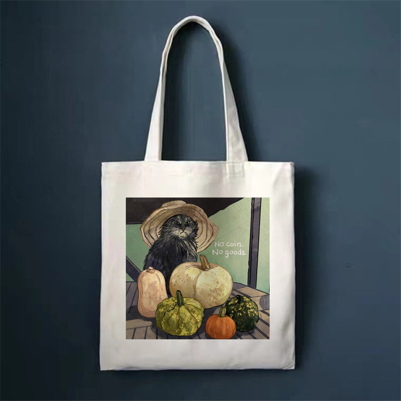 Canvas tote bag, white, with dark cat and pumpkins print.