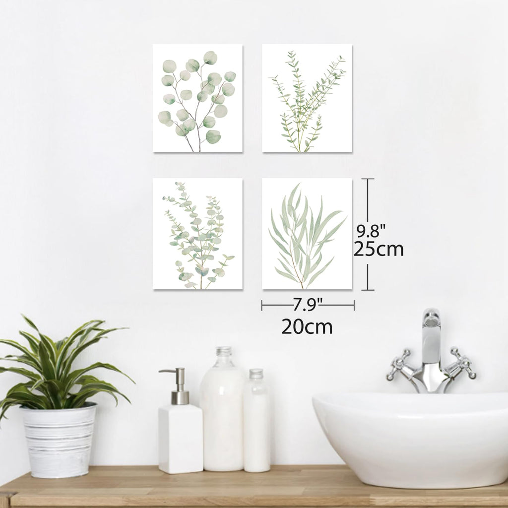 Four framed botanical leaf canvas prints on a wall with leaf illustrations