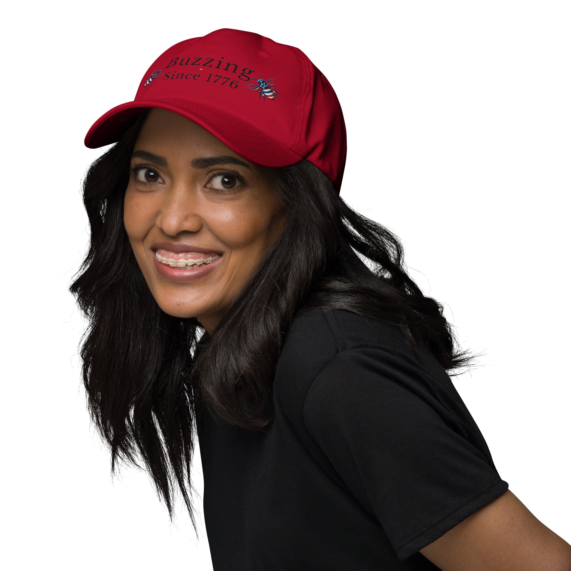 Cranberry dad hat with “Buzzing Since 1776” and bee graphic, worn