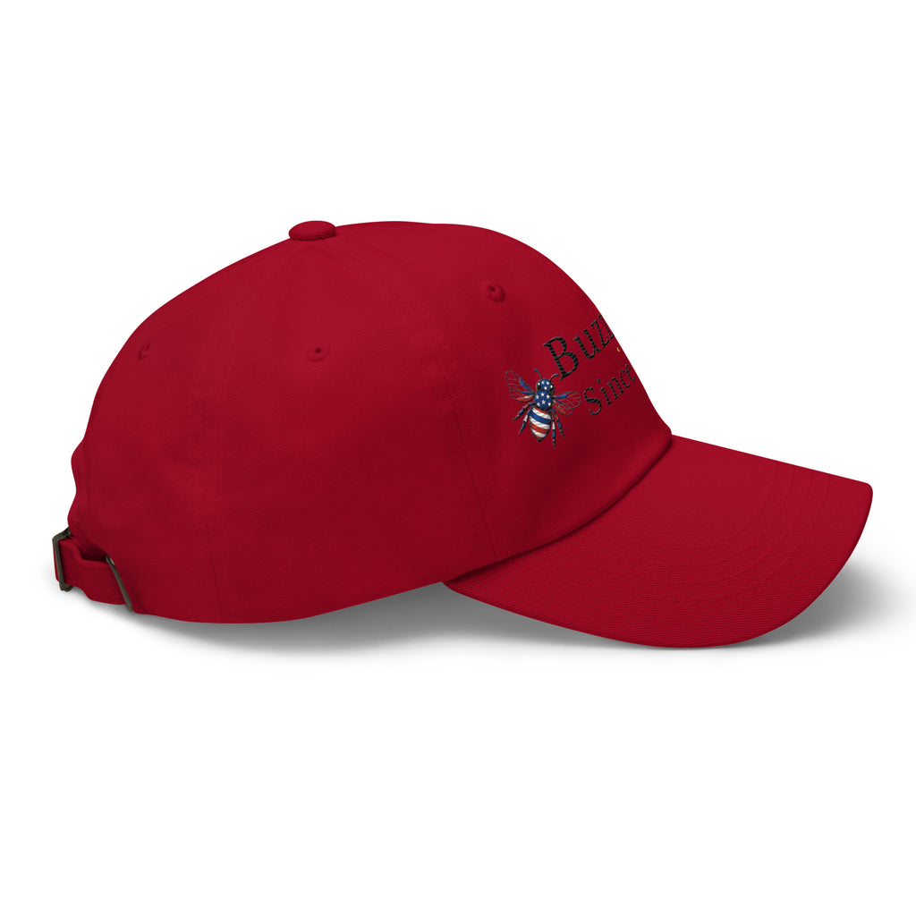Red dad hat with curved brim and bee graphic on side