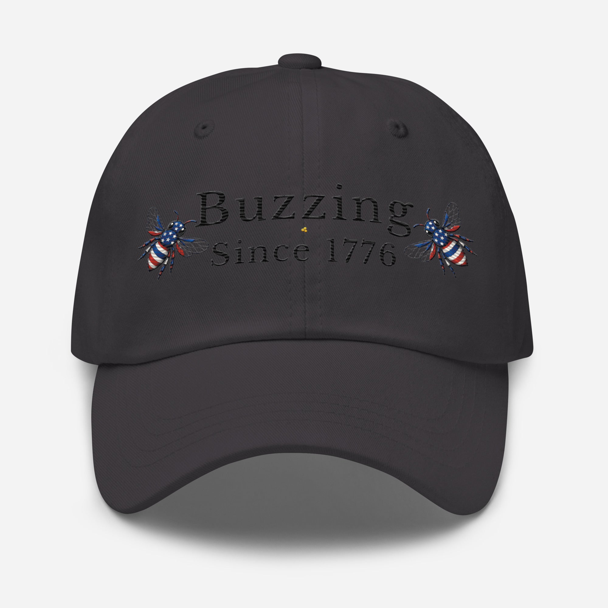 Dark grey dad hat with “Buzzing Since 1776” text and bee graphic embroidery on front